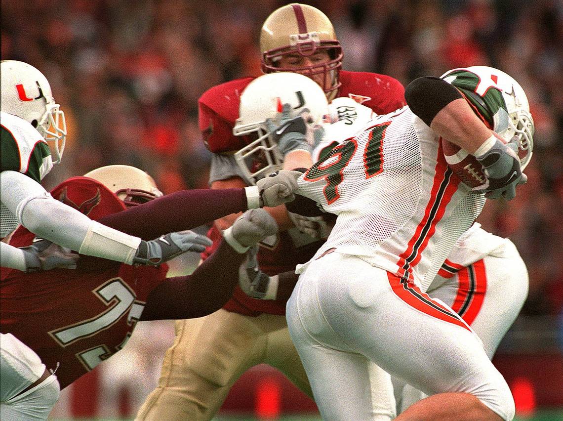Chestnut Hill, MA - 11/10/01 -Boston Globe Staff Photo: Barry Chin. BC’s Mark Parenteau makes a last ditch grab but gets only jersey as Miami’s Matt Walters pulls in a tipped pass from BC QB Brian St. Pierre on the way to running it back for a last minute TD stopping BC’s chance of a miraculous win over #1 ranked Miami at home today. CHIN, Barry GLOBE STAFF