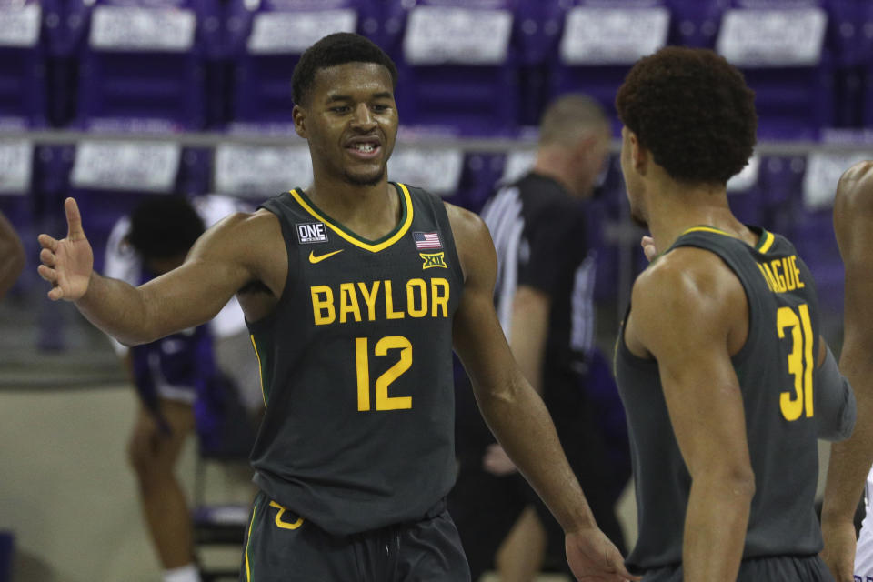 Baylor guard Jared Butler (12) celebrates the win over TCU with guard MaCio Teague (31) after an NCAA college basketball game, Saturday, Jan. 9, 2021, in Fort Worth, Texas. (AP Photo/ Richard W. Rodriguez)