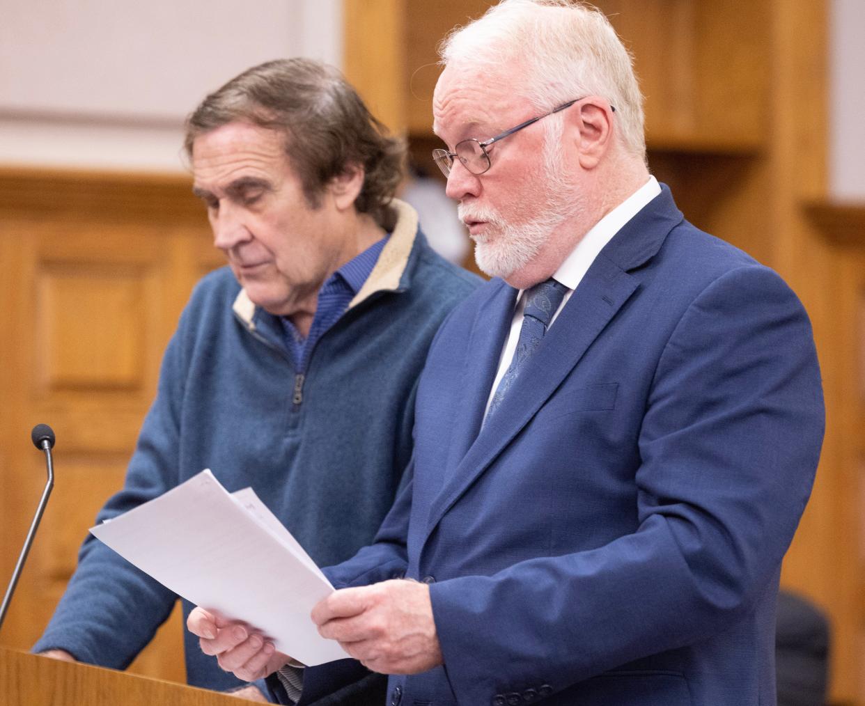 Defense attorney Jeffrey Jakmides, right, reads a statement to Stark County Common Pleas Judge Natalie Haupt on behalf of former attorney William Sparks, left. Sparks was sentenced to prison for stealing nearly $900,000 from former clients.