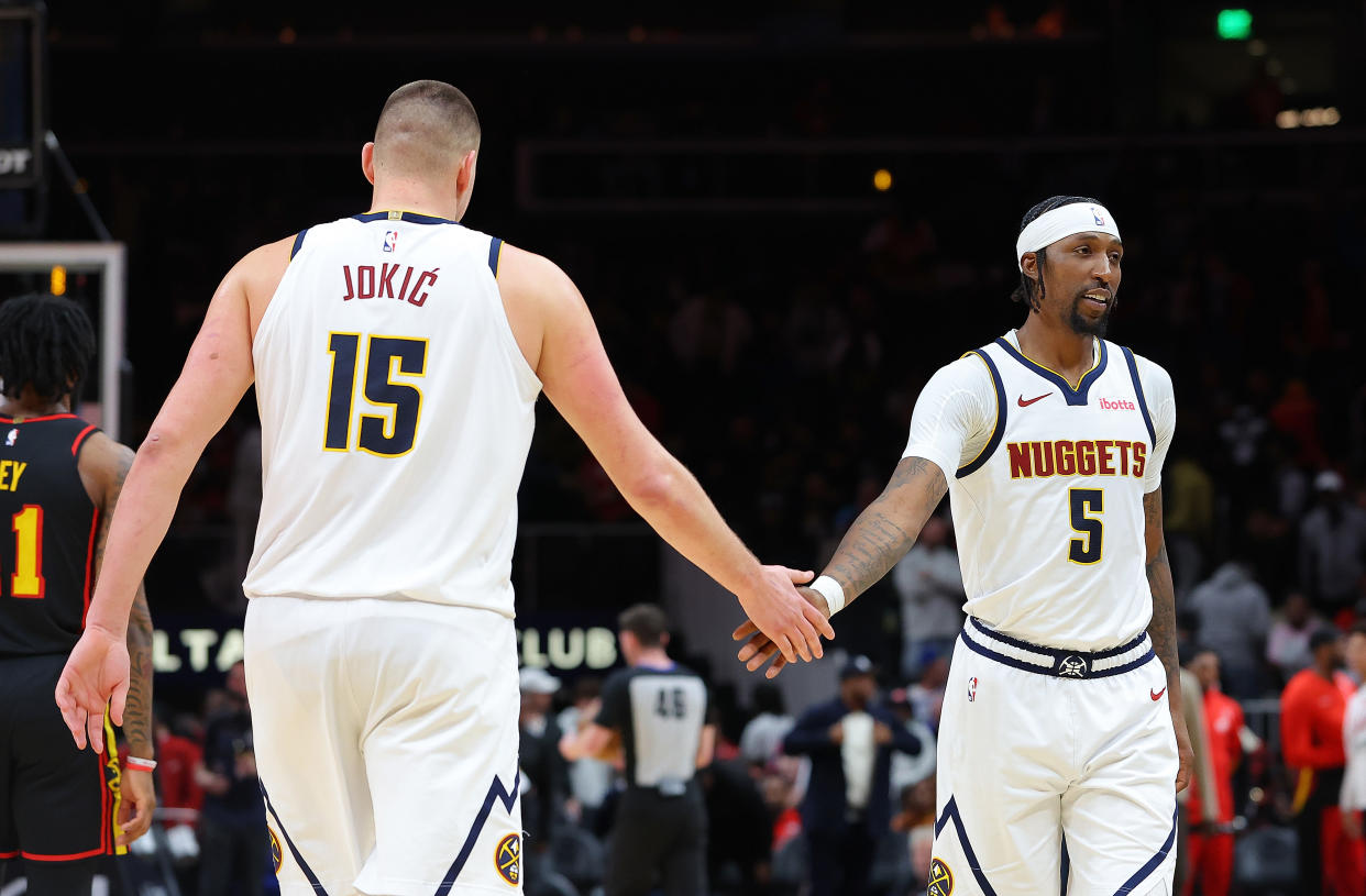 ATLANTA, GEORGIA - DECEMBER 11:  Kentavious Caldwell-Pope #5 and Nikola Jokic #15 of the Denver Nuggets reacts in the final seconds of their 129-122 win over the Atlanta Hawks during the fourth quarter at State Farm Arena on December 11, 2023 in Atlanta, Georgia.  NOTE TO USER: User expressly acknowledges and agrees that, by downloading and/or using this photograph, user is consenting to the terms and conditions of the Getty Images License Agreement.  (Photo by Kevin C. Cox/Getty Images)