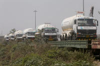 FILE- In this April 19, 2021 file photo, empty tankers are loaded on a train wagon at the Kalamboli goods yard in Navi Mumbai, Maharashtra state, India, before they are transported to collect liquid medical oxygen from other states. The western Maharashtra state, which is worst hit by the coronavirus is facing a shortage of the gas used for the treatment of COVID-19 patients. India's health system is collapsing under the worst surge in coronavirus infections that it has seen so far. (AP Photo/Rafiq Maqbool, File)