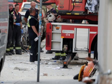 Rescue teams arrive at the site where a building collapsed in Vienna