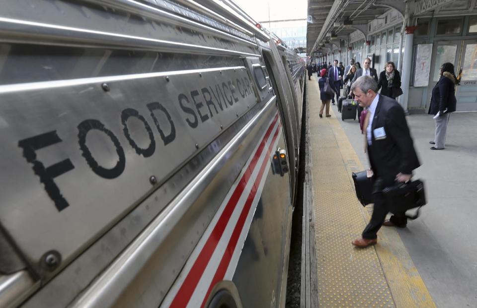 Some of the 1,000 lobbyists, business owners and politicians rush to their assigned cars of the train taking them to Washington, D.C., Thursday, Feb. 16, 2017 in Trenton, N.J. The state Chamber of Commerce's 80th annual trip — nicknamed the "Walk to Washington" because rail riders generally pace the train's corridors schmoozing and handing out business cards — comes after a national election that hinged in part on repudiating insiders and establishment politics. (AP Photo/Mel Evans)