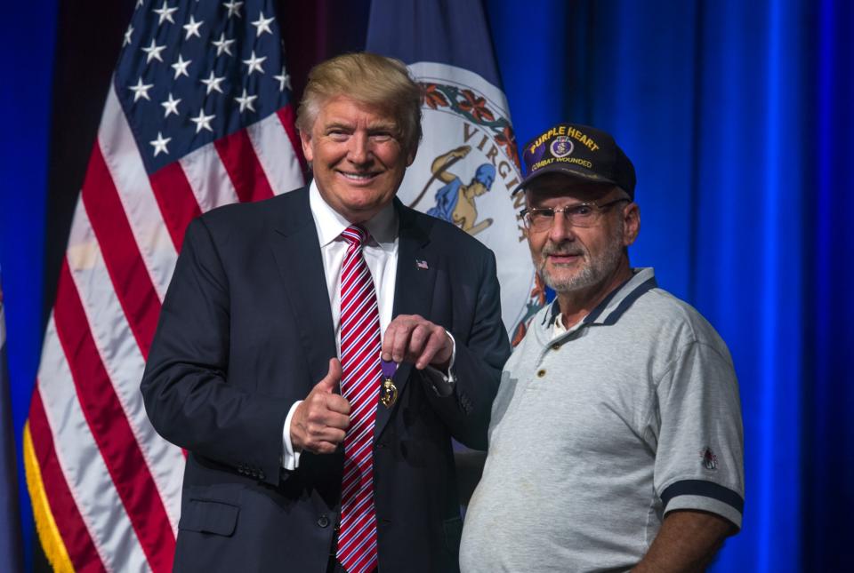 Donald Trump poses with Louis Dorfman (R) after Dorfman gave Trump his Purple Heart medal at a rally at Briar Woods High School in Ashburn, Virginia on August 2, 2016. (Photo: Jim Lo Scalzo/ EPA/)