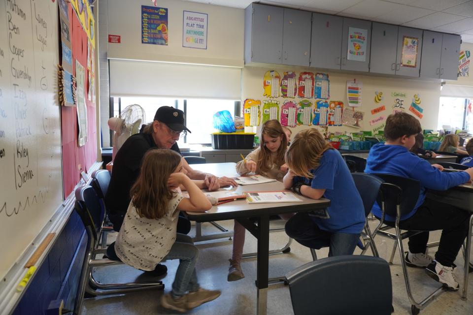John Steinbrecher, who volunteers as a foster grandparent, helps out students at Chenango Forks Elementary School on Monday, April 15, 2024.