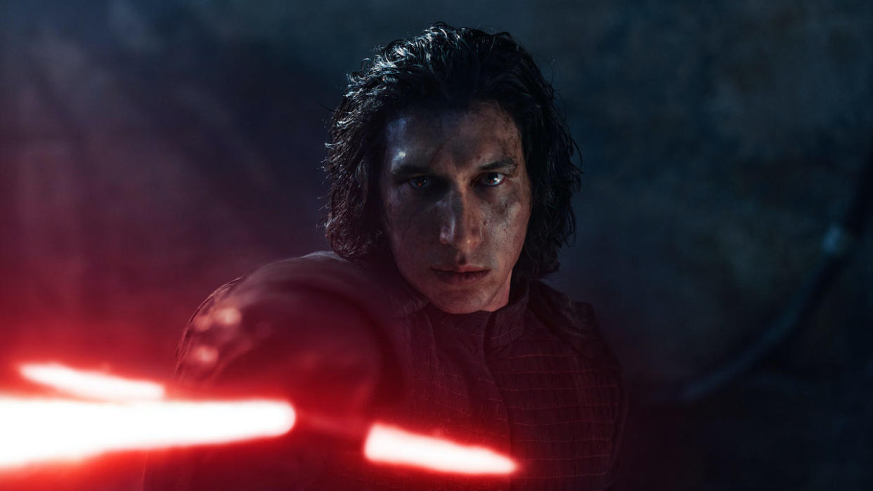  Adam Driver's Kylo Ren pointing red lightsaber in Star Wars: The Rise of Skywalker. 