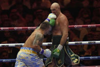 Ukraine's Oleksandr Usyk, left, lands a blow on Britain's Tyson Fury during their undisputed heavyweight world championship boxing fight at the Kingdom Arena in Riyadh, Saudi Arabia, Sunday, May 19, 2024. (AP Photo/Francisco Seco)