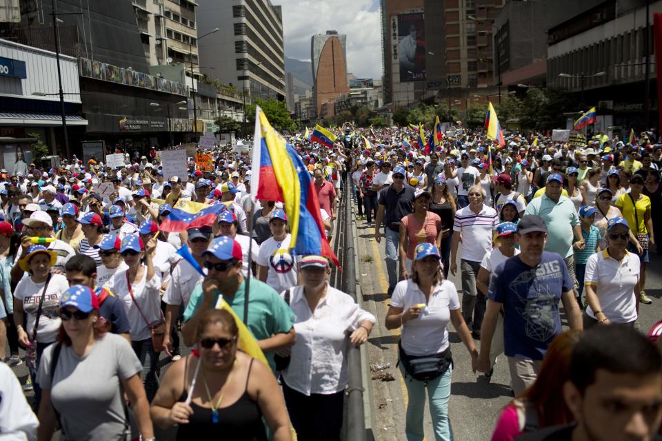 Anti-government demonstrators march in Caracas, Venezuela, Sunday, March 2, 2014. Since mid-February, anti-government activists have been protesting high inflation, shortages of food stuffs and medicine, and violent crime in a nation with the world's largest proven oil reserves. (AP Photo/Rodrigo Abd)