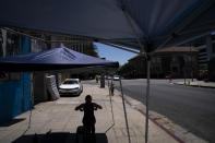 FILE - In this Aug. 7, 2020, file photo, a woman works out at an outdoor gym in Los Angeles. Los Angeles County could move into the next phase of reopening with fewer restrictions as early as next week, though any actual lifting of coronavirus-related constraints would not happen immediately, health officials said Wednesday, March 3, 2021. (AP Photo/Jae C. Hong, File)