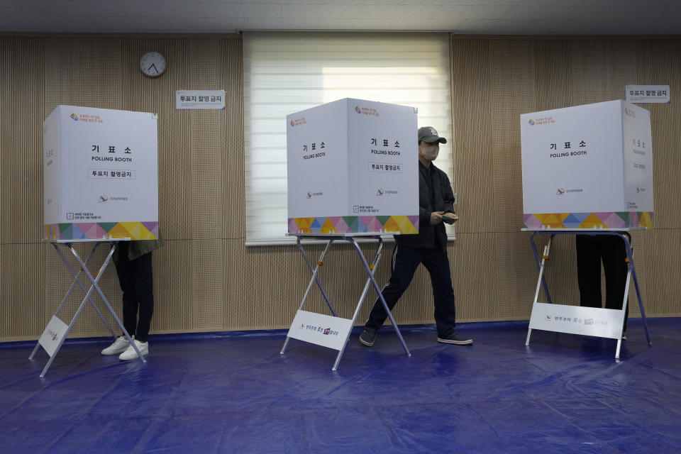 A voter exits out to cast his vote for the parliamentary election at a polling station in Seoul, South Korea, Wednesday, April 10, 2024. South Korean President Yoon Suk Yeol faces a crucial referendum Wednesday in a parliamentary election that could determine whether he becomes a lame duck or enjoys a mandate to pursue key policies for his remaining three years in office. (AP Photo/Ahn Young-joon)