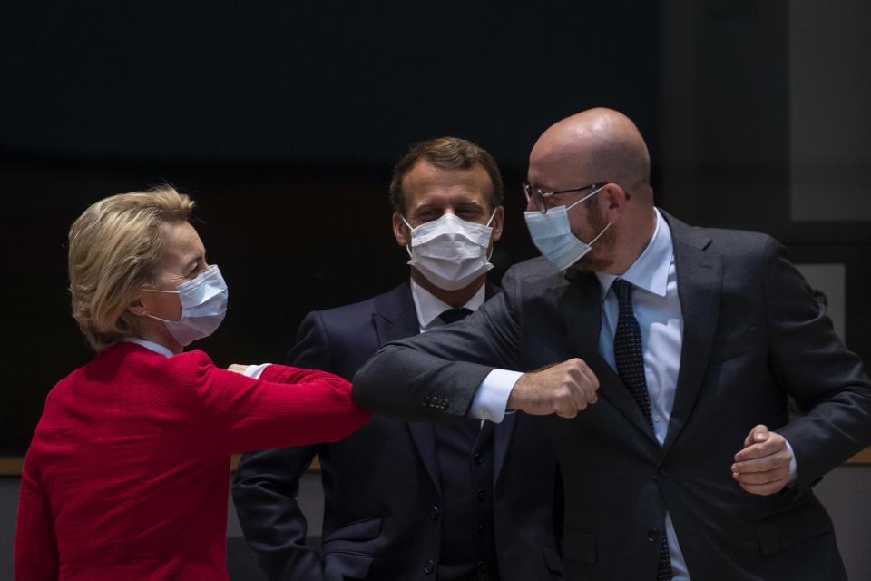 FILE - In this Saturday, July 18, 2020 file photo, European Commission President Ursula von der Leyen, left, greets European Council President Charles Michel with an elbow bump during an EU summit in Brussels. The European Council announced on Tuesday, Sept. 22, 2020 that the European Union summit scheduled to take place on Sept. 24-25, 2020 has been postponed for a week because EU Council President Charles Michel has gone into quarantine as a precaution after a security officer in which he had close contact tested positive for COVID-19. (AP Photo/Francisco Seco, Pool, File)