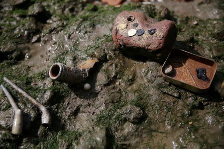 Objects recently excavated by mudlarks Andy Johansen and Ian Smith are presented on the bank of the River Thames in London, Britain May 22, 2016. REUTERS/Neil Hall