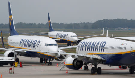 FILE PHOTO: A Ryanair airplane taxis past two parked aircraft at Weeze Airport, near the German-Dutch border, during a strike of Ryanair airline crews, protesting the slow progress in negotiating a collective labour agreement in Weeze, Germany, September 12, 2018. REUTERS/Wolfgang Rattay/File Photo