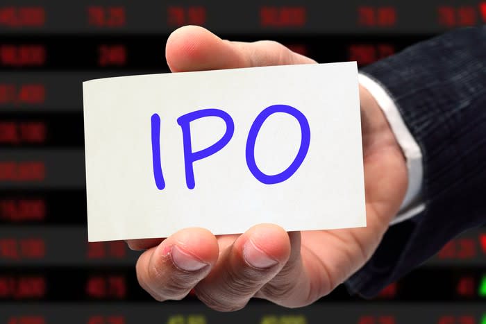 IPO on a card held by a hand.