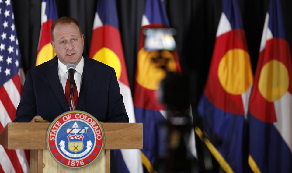 Colorado Governor Jared Polis makes a point duiring a news conference to update the state's efforts to check the spread of the new coronavirus Monday, May 11, 2020, in Denver. (AP Photo/David Zalubowski)