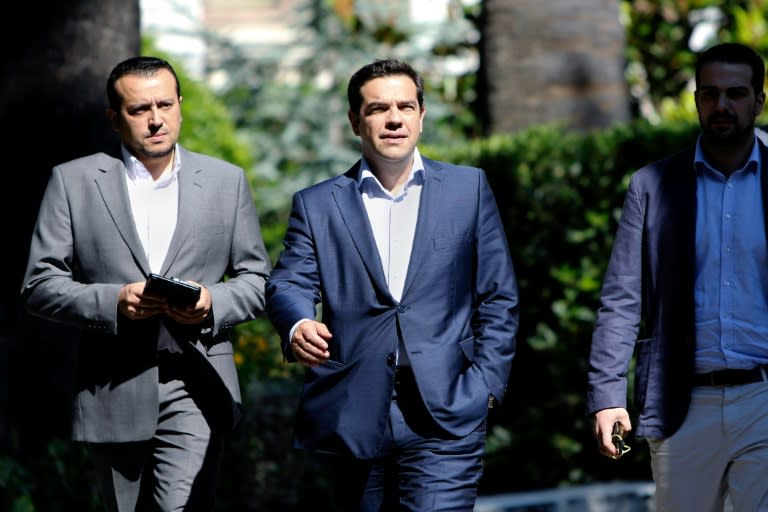 Greek Minister of State Nikos Pappas (L), with Prime Minister Alexis Tsipras (C), described the court decision to block reforms of the private TV sector as "unjust"