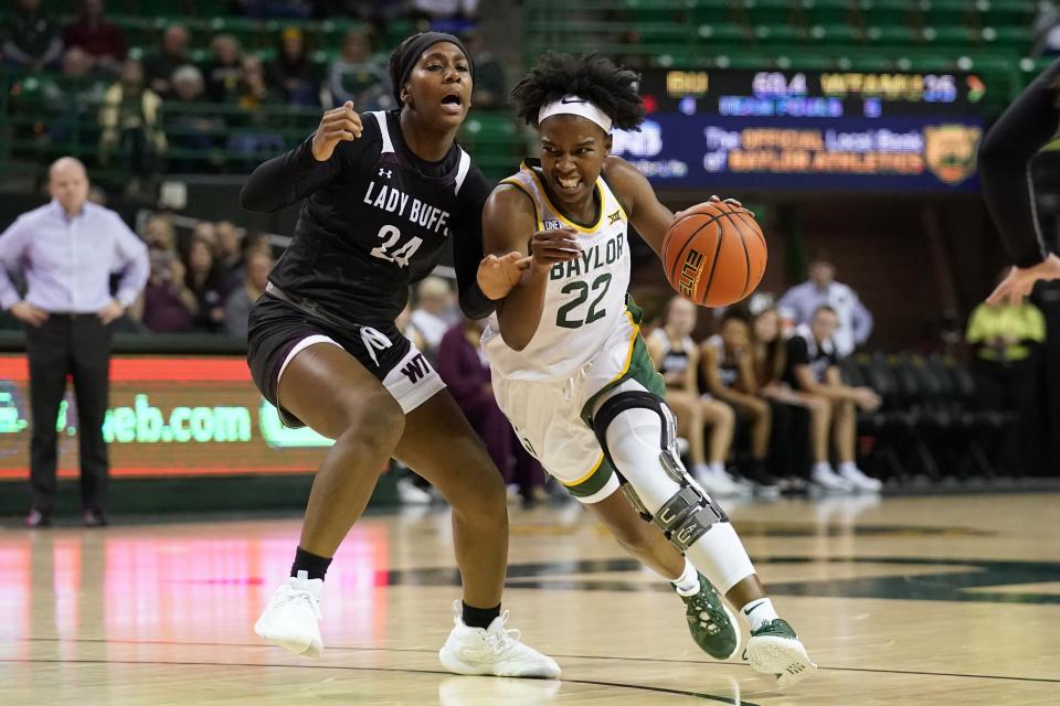 West Texas A&M guard Jillian Sowell (24) defends against a drive to the basket by Baylor guard Kamaria McDaniel (22) in the first half of an exhibition NCAA college basketball game in Waco, Texas, Wednesday, Nov. 3, 2021. (AP Photo/Tony Gutierrez)