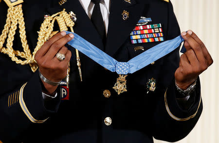A military aide holds the Medal of Honor before U.S. President Donald Trump awarded it to James McCloughan, who served in the U.S. Army during the Vietnam War, during a ceremony at the White House in Washington, U.S. July 31, 2017. REUTERS/Joshua Roberts