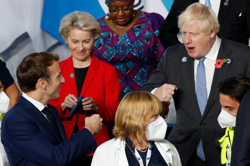 French President Emmanuel Macron (L) gestures as he speaks to British Prime Minister Boris Johnson (R) during the G20 Summit at the convention center 