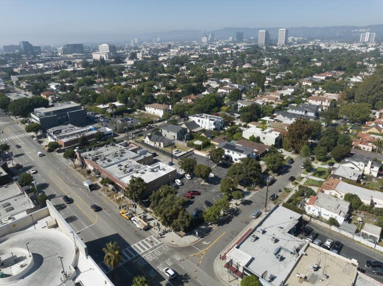 LOS ANGELES, CA - October 18: The city proposed a 33-bed interim homelessness shelter at a current parking lot, lower center, at Midvale Avenue and Pico Boulevard in Los Angeles. The project will provide onsite laundry, housing units with ensuite bathrooms and services for people experiencing homelessness. Some neighbors oppose the project arguing that it will be too close to residential areas. Photographed in Westside on Wednesday, Oct. 18, 2023 in Los Angeles, CA. (Myung J. Chun / Los Angeles Times)