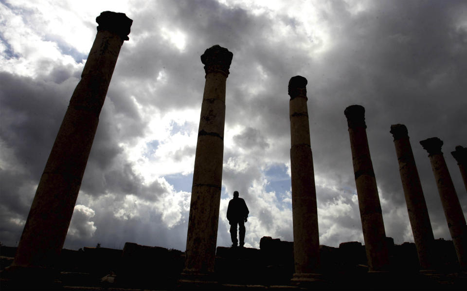 FILE - In this Feb. 11, 2009, file photo, a tourist walks around in the ancient Roman city of Jerash, Jordan, north of Amman. Jordanian officials say an attacker has stabbed a number of tourists and their tour guide at a popular archaeological site in northern Jordan. The wounded were taken to a hospital and the attacker was arrested. (AP Photo /Mohammad abu Ghosh, File)