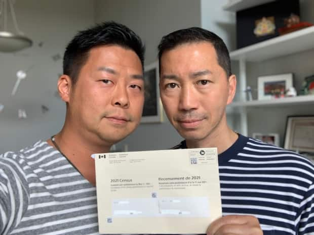 Henry Lam, left, and his husband, Guy Ho, want fellow Canadian Hong Kongers to note their identity on the 2021 long-form census. (Submitted by Henry Lam - image credit)