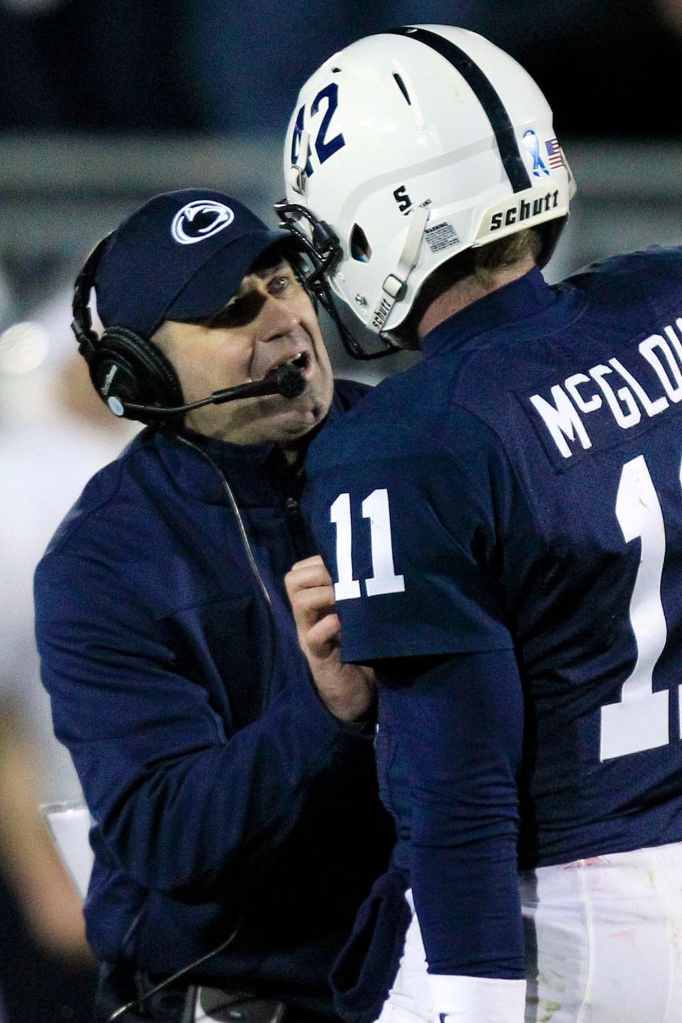 Penn State quarterback Matthew McGloin (11) gets a play from Penn State head coach Bill O'Brien during the fourth quarter of an NCAA college football game against Wisconsin in State College, Pa., Saturday, Nov. 24, 2012. Penn State won in overtime 24-21. (AP Photo/Gene J. Puskar)