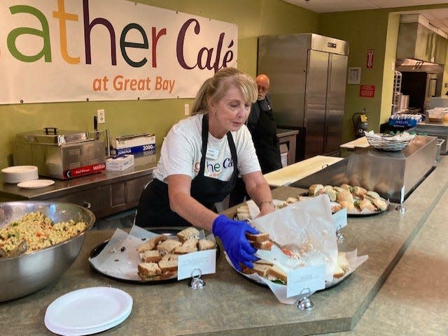 Gather volunteer Linda Bloedel serves the community at the grand opening of the Gather Cafe at Great Bay Community College in Portsmouth Thursday, Sept. 8, 2022.