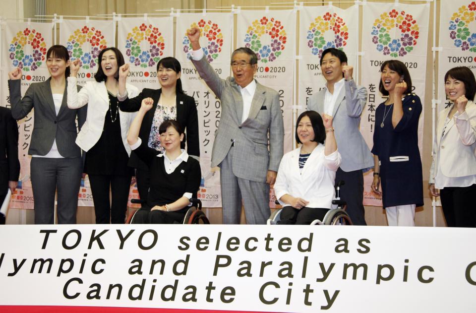Tokyo Gov. Shintaro Ishihara, center, chairman of Tokyo 2020 Council, shows his spirit with Japanese Olympians and Paralympians during a press conference in Tokyo Thursday, May 24, 2012, after learning the Japanese capital was selected among the three finalists in the announcement of 2020 Olympic and Paralympic Games candidate cities in Quebec City, Canada. They are: Paralympians, swimmer Mayumi Narita, front left, and chair skier Kuniko Obinata, front right, and Olympians, from left, volleyball players, Kana Oyama and Motoko Obayashi, swimmers, Ai Shibata and Daichi Suzuki, synchronized swimmer Mikako Kotani and short track speed skater Ikue Teshigawara. (AP Photo/Koji Sasahara)