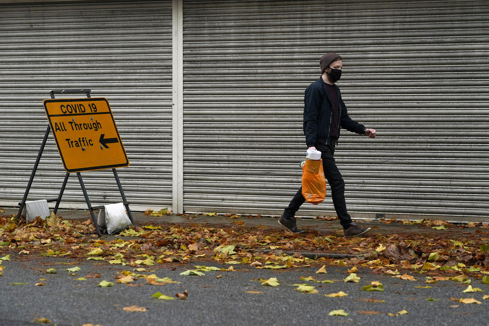 WARRINGTON, ENGLAND - OCTOBER 27: People wear face masks in Warrington town centre as the borough enters Covid-19 Tier 3 'Very High' lockdown restrictions on October 27, 2020 in Warrington, England. Public Health England data over the last seven days showed 830 new positive cases of coronavirus (Covid-19) forcing the town into Tier 3 restrictions. (Photo by Christopher Furlong/Getty Images)