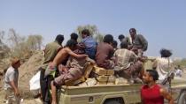 People sit on ammunition boxes they took from army depots in Yemen's southern port city of Aden March 27, 2015. REUTERS/Anees Manousr