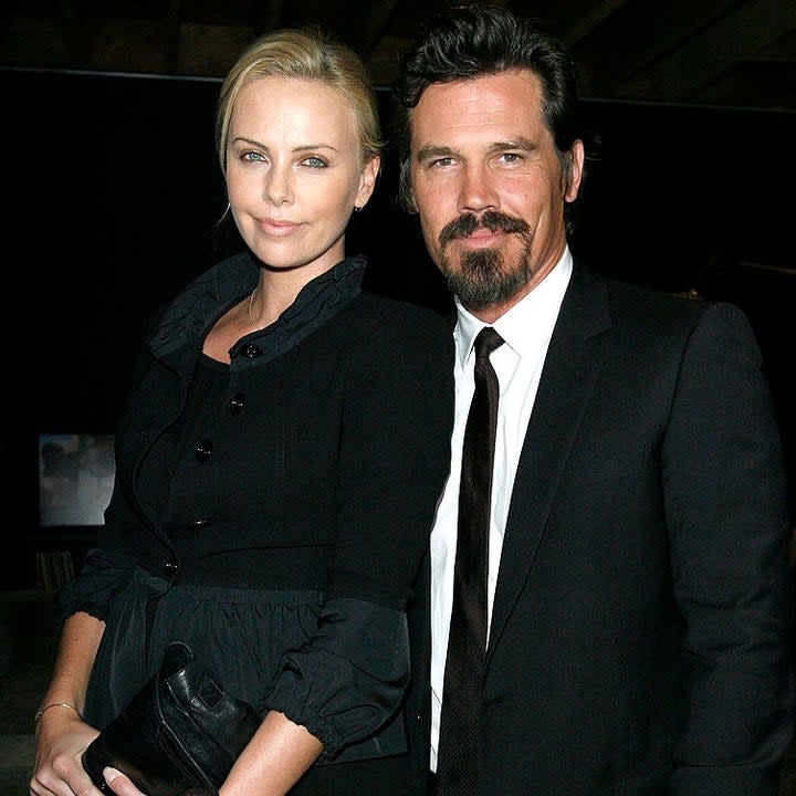 Josh Brolin and Charlize Theron pose together on a red carpet