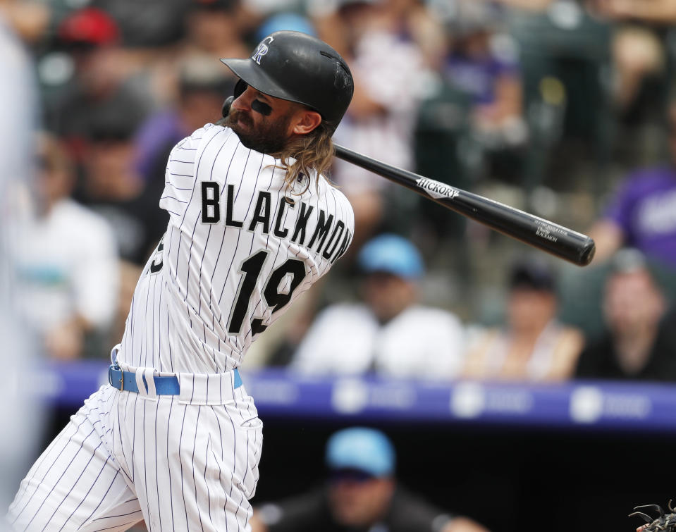 Colorado Rockies center fielder Charlie Blackmon follows the flight of his RBI-single off San Diego Padres relief pitcher Phil Maton in the sixth inning of a baseball game Sunday, June 16, 2019, in Denver. (AP Photo/David Zalubowski)
