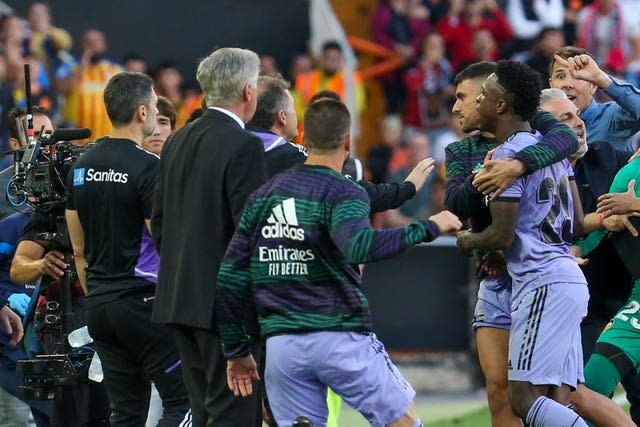 Vinicius Junior, right, leaves the pitch after being shown a red card 