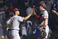 Cincinnati Reds' Shogo Akiyama, left, and catcher Tyler Stephenson celebrate the team's 8-2 win one the Chicago Cubs in a baseball game Wednesday, July 28, 2021, in Chicago. (AP Photo/Charles Rex Arbogast)