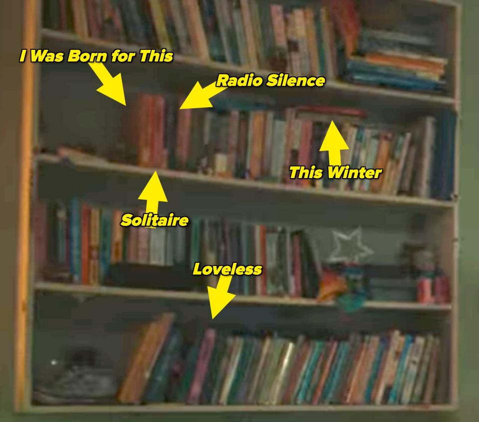 Bookshelf with "I Was Born for This," "Radio Silence," "This Winter," "Solitaire," and "Loveless" labeled