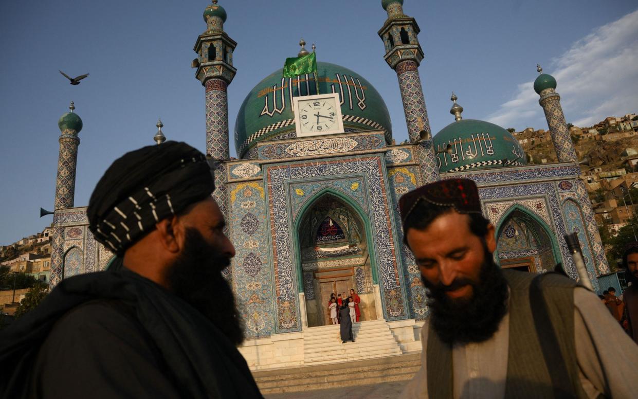 Taliban stand guard in front of the the Sakhi Shah-e Mardan Shrine and mosque in Kabul - DANIEL LEAL /AFP via Getty Images