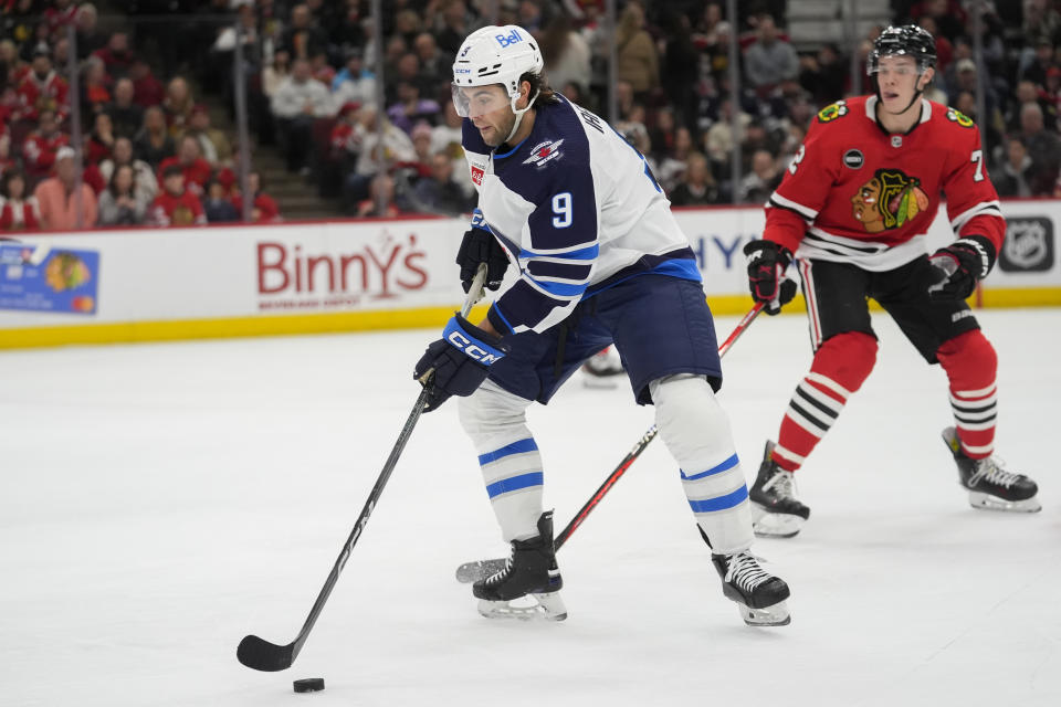 Winnipeg Jets left wing Alex Iafallo (9) handles the puck during the first period of an NHL hockey game against the Chicago Blackhawks, Friday, Feb. 23, 2024, in Chicago. (AP Photo/Erin Hooley)