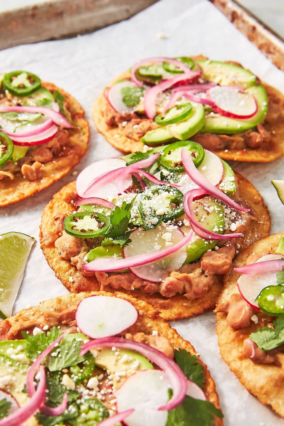 <p>Tostada shells can be tricky to find, so we made our own! Hot and fresh, there's so much more flavor. All that said, these insanely creamy <a href="https://www.delish.com/cooking/recipe-ideas/g41428477/bean-recipes/" rel="nofollow noopener" target="_blank" data-ylk="slk:beans;elm:context_link;itc:0;sec:content-canvas" class="link ">beans</a> + quick <a href="https://www.delish.com/cooking/recipe-ideas/a27245453/pickled-red-onions-recipe/" rel="nofollow noopener" target="_blank" data-ylk="slk:pickled red onions;elm:context_link;itc:0;sec:content-canvas" class="link ">pickled red onions</a> would taste amazing on anything, including a packaged tostada shell. 😉</p><p>Get the <strong><a href="https://www.delish.com/cooking/recipe-ideas/a27168236/tostada-recipe/" rel="nofollow noopener" target="_blank" data-ylk="slk:Best-Ever Mexican Tostadas recipe;elm:context_link;itc:0;sec:content-canvas" class="link ">Best-Ever Mexican Tostadas recipe</a></strong>.</p>