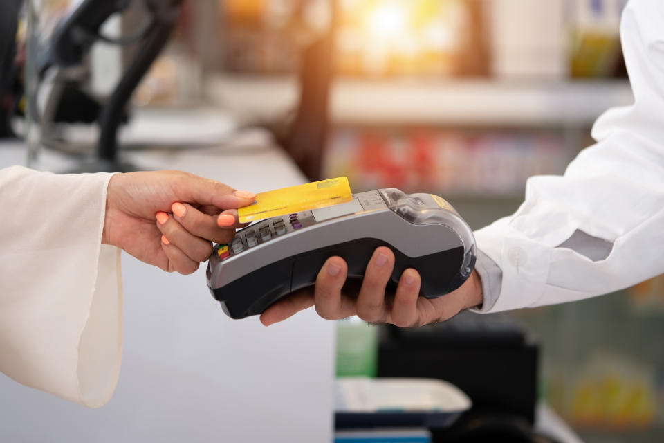 credit card payment service. Customer paying for order of cheese in grocery shop.Credit card payment service The customer pays to order cheese in the pharmacy.