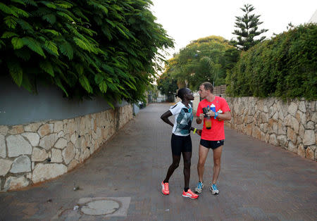 Lonah Chemtai, a Kenyan-born runner who will represent Israel in the women's marathon at the 2016 Rio Olympics, and her husband and coach, Israeli Dan Salpeter, speak before training near their house in Moshav Yanuv, central Israel July 14, 2016. REUTERS/Baz Ratner