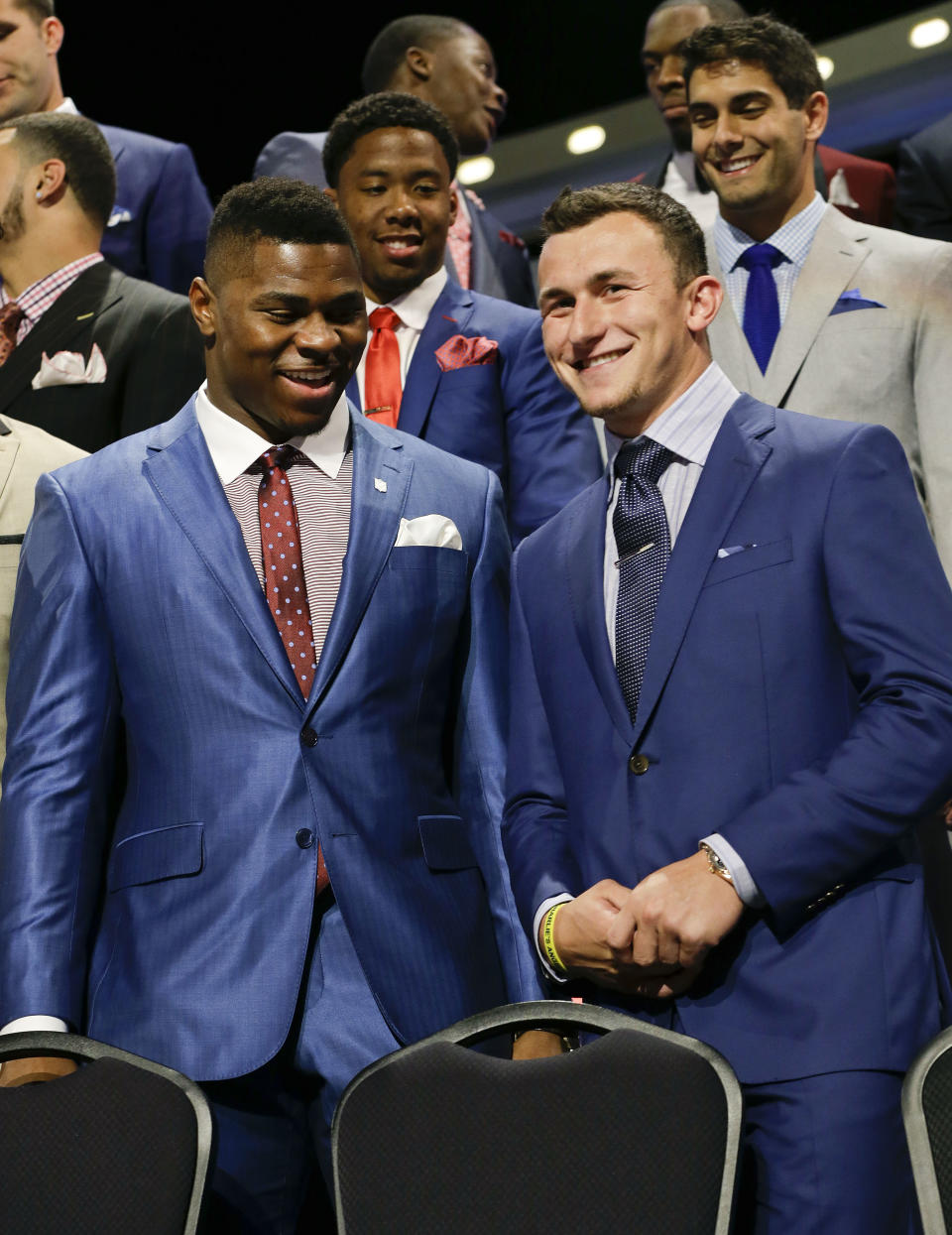 Buffalo Khalil Mack, left, greets Texas A&M quarterback Johnny Manziel as they are introduced during the first round of the 2014 NFL Draft, Thursday, May 8, 2014, in New York. (AP Photo/Frank Franklin II)