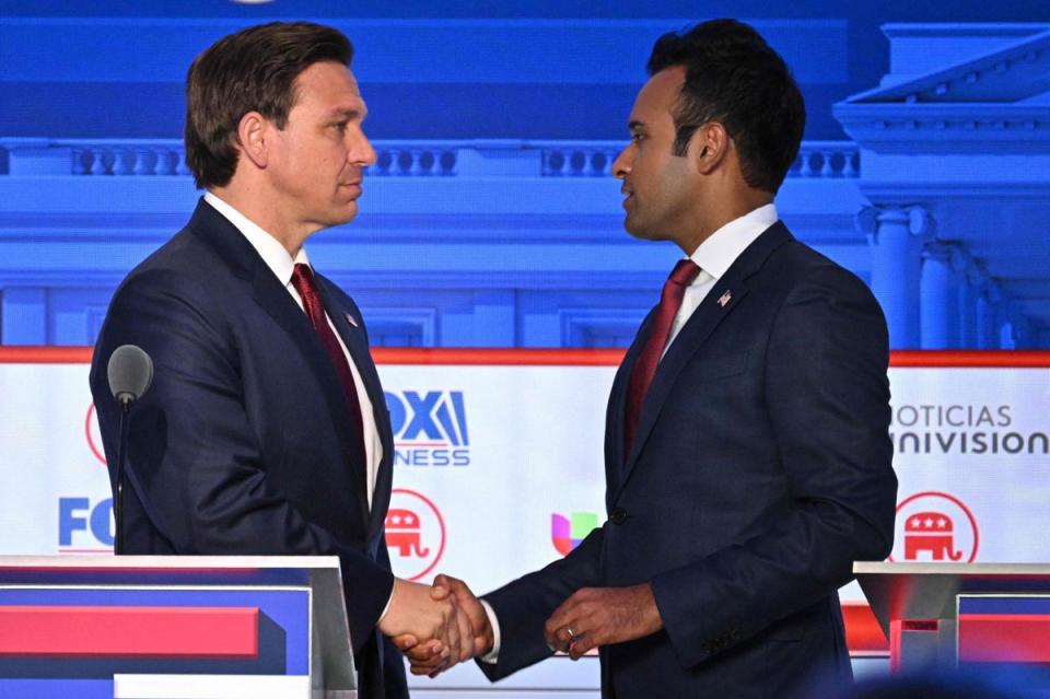 Entrepreneur Vivek Ramaswamy (R) shakes hands with Florida Governor Ron DeSantis following the second Republican presidential primary debate (AFP via Getty Images)