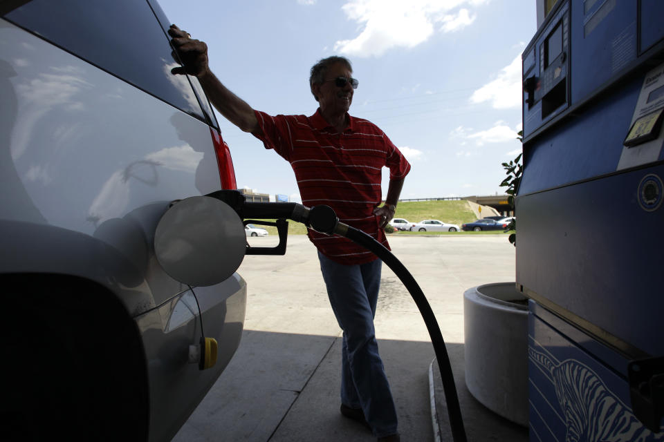 Larry Barnard stands by as he fills his car with gasoline at an Exxon station Thursday, June 30, 2011, in Farmers Branch, Texas. (AP Photo/Tony Gutierrez)