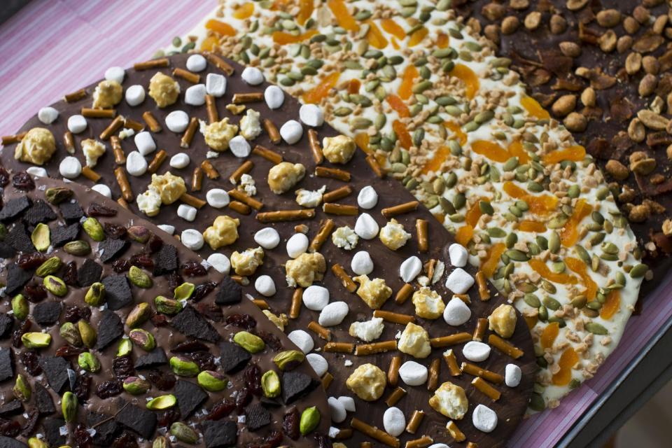In this image taken on Jan. 21, 2013, four variations of Valentine's Day chocolate bark are shown in Concord, N.H. You can top the chocolate with whatever your love loves. (AP Photo/Matthew Mead)