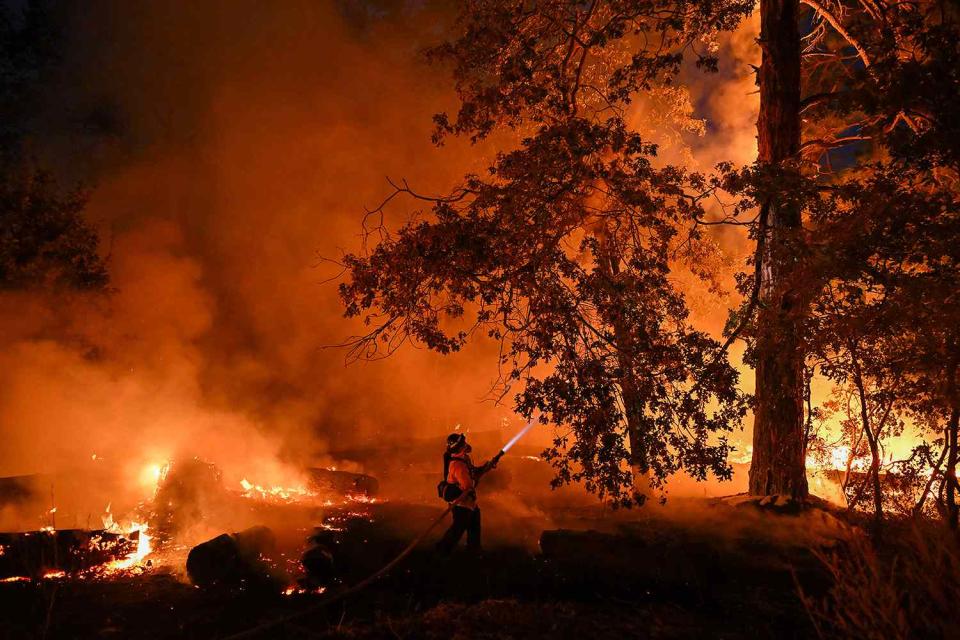 <p>Tayfun Coskun/Anadolu via Getty Images</p> Crews are battling against to flames as Park Fire of wildfires continue in Chico, California