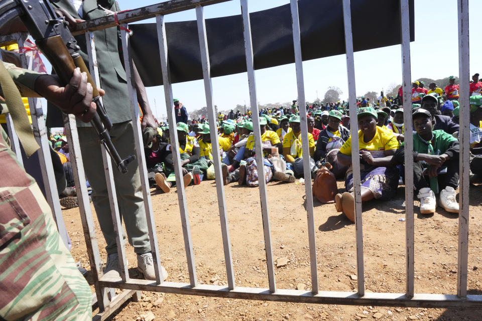 An armed soldier stands guard at a rally attended by Zimbabwean President Emmerson Mnangagwa in Harare, Wednesday, Aug. 9, 2023. Mnangagwa addressed thousands of supporters in a speech laden with calls for peace, days after his supporters were accused of stoning an opposition activist to death ahead of general elections set for Aug. 23. (AP Photo/Tsvangirayi Mukwazhi)