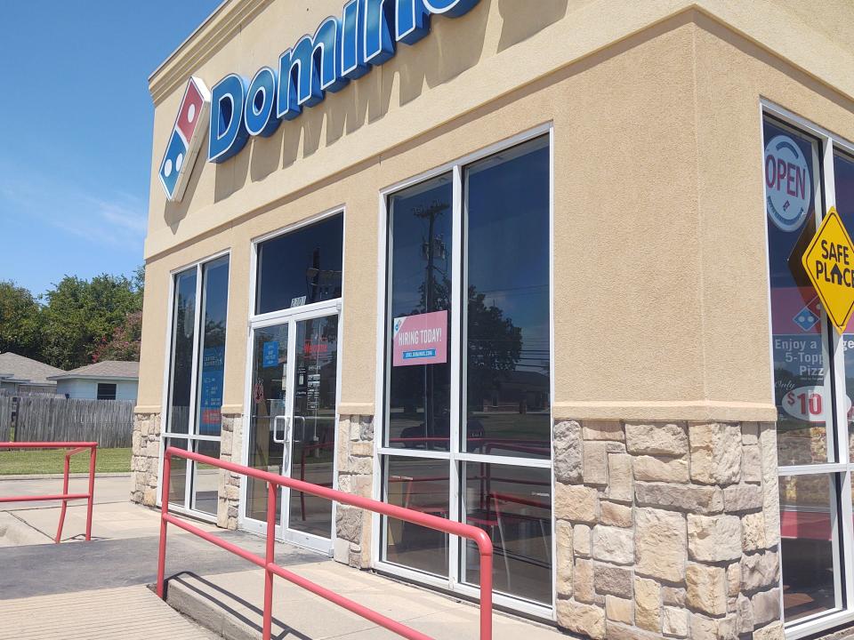 A now hiring sign sits in the windows of the Loy Lake Domino's Pizza location in Sherman in this file photo from August. Many employers that are looking for workers during an extended labor shortage.