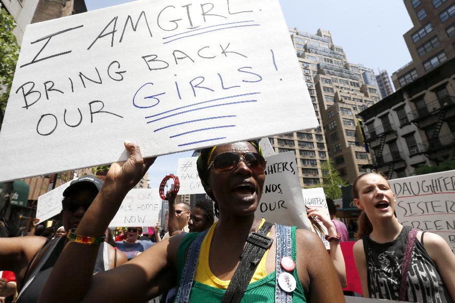 Brigid Turner, a Jamaican national who lives in Brooklyn, holds a sign while chanting during a rally in front of the Nigerian consulate, Saturday, May 10, 2014, in New York. Dozens gathered to join the international effort to rescue the 276 schoolgirls being held captive by Islamic extremists in northeastern Nigeria. As the worldwide effort got underway the weakness of the Nigerian military was exposed in a report issued by Amnesty International. (AP Photo/Julio Cortez)