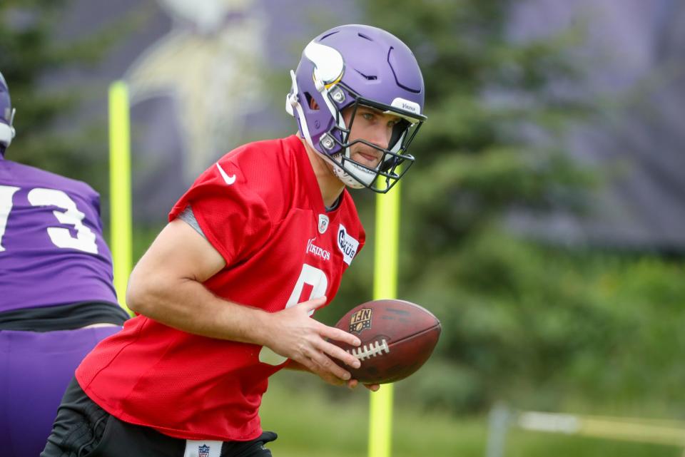 Minnesota Vikings quarterback Kirk Cousins takes part in drills at the NFL football team's practice facility in Eagan, Minn., Tuesday, May 17, 2022.